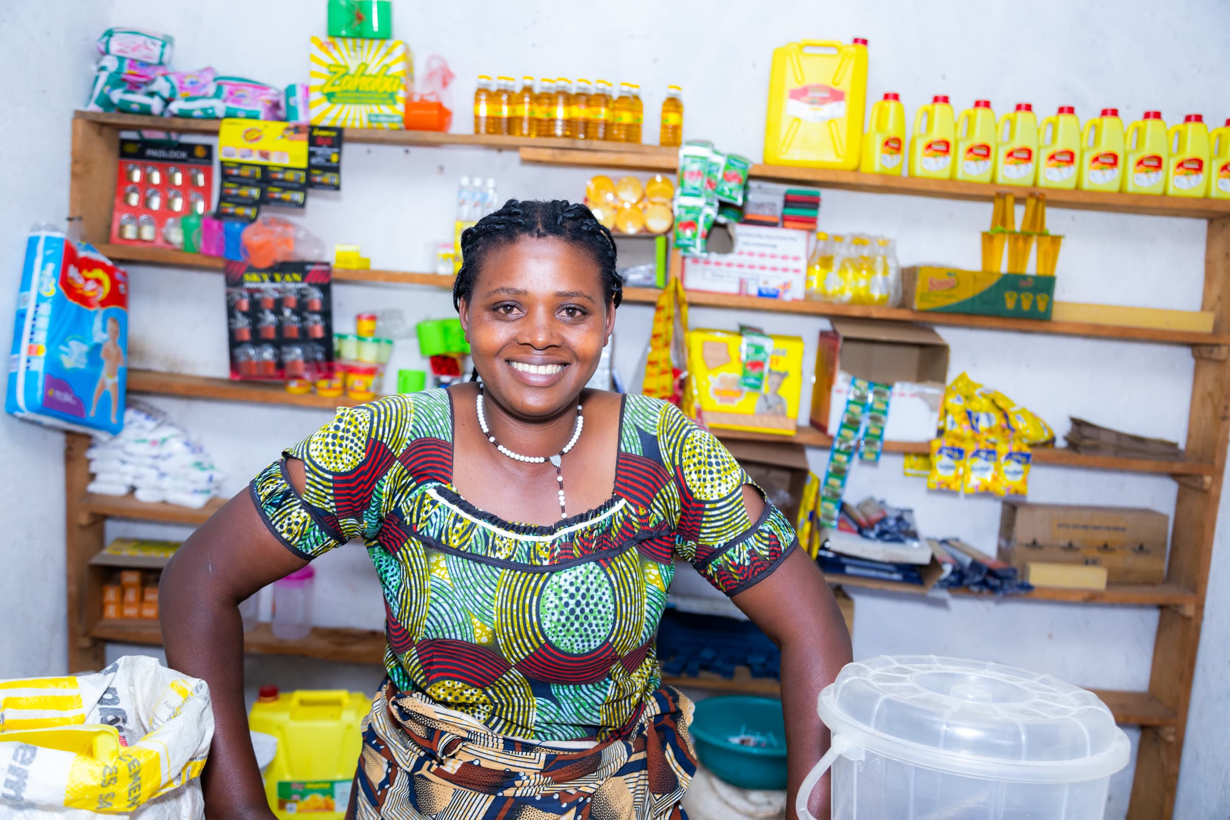 A woman standing in the shop she runs, stocked floor to ceiling